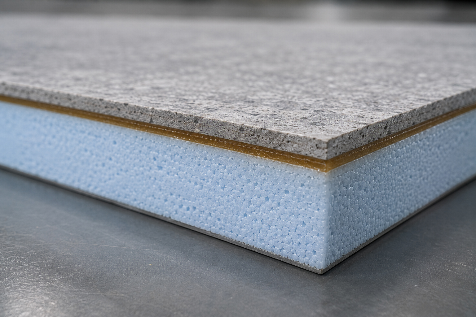 Cross-section of an insulation integrated panel showing the foam core bonded to a facing with a PUGLUE PU-50 glue line