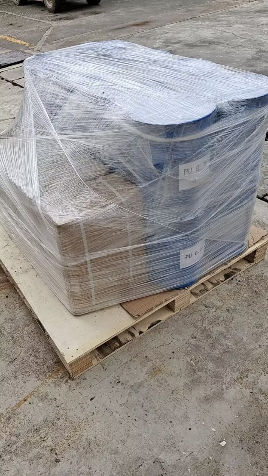 Palletized PU adhesive drums stretch-wrapped for export to India